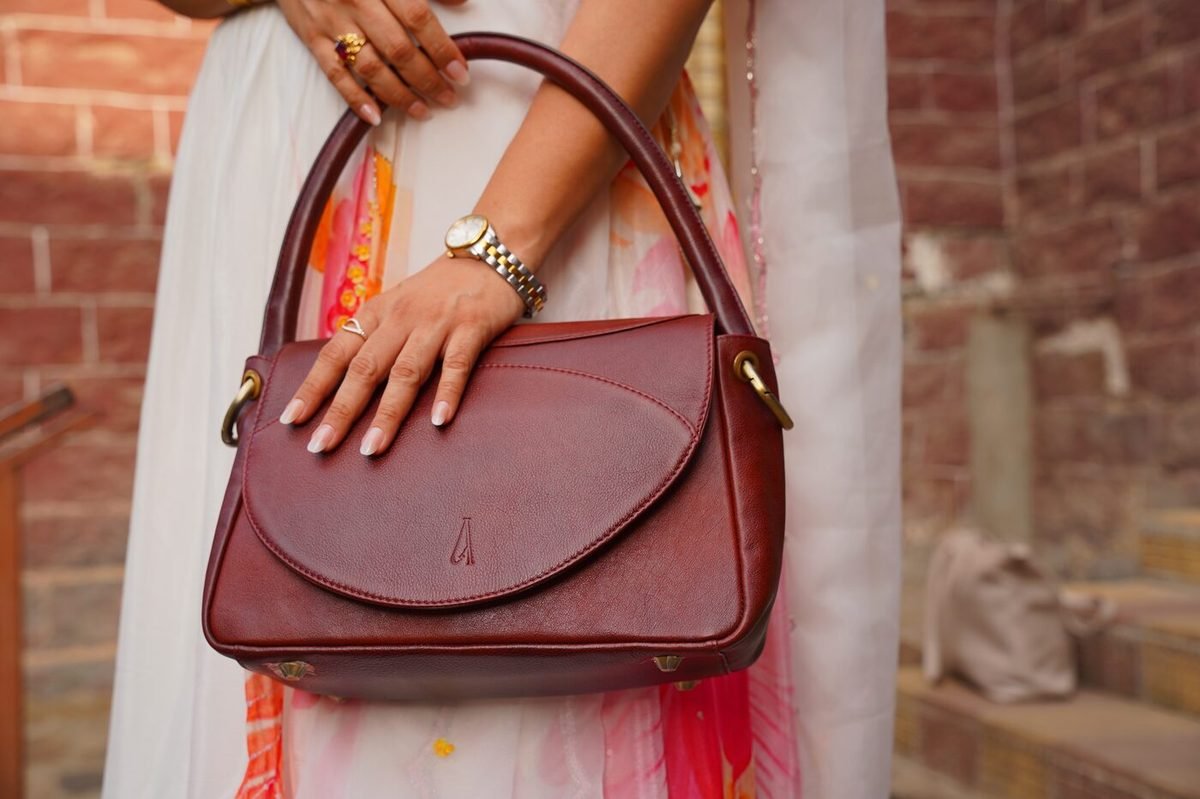 Ardori shoulder bag carried against a brick wall