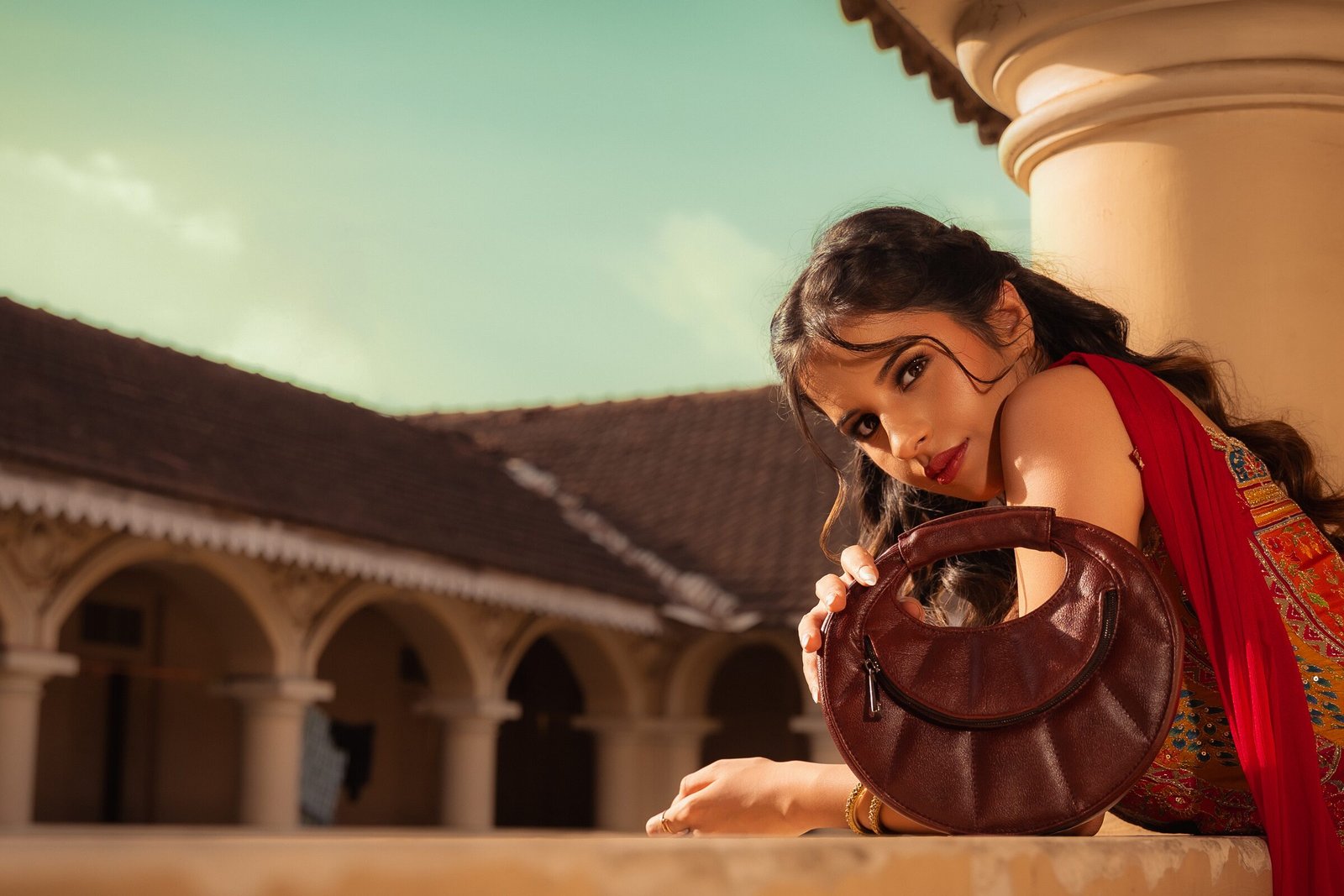 An Ardori handbag carried through an Indian courtyard